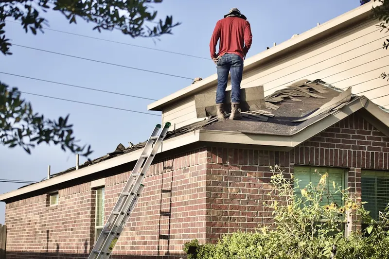 Professional roofer working on a residential roof in Harbor Hills